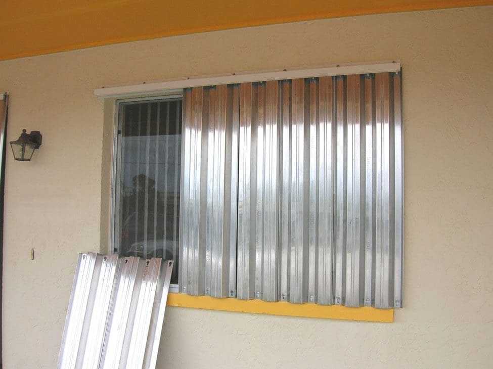 Coastal hurricane shutters: silver accordion style - american hurricane shutters Silver accordion hurricane shutters for coastal home protection.