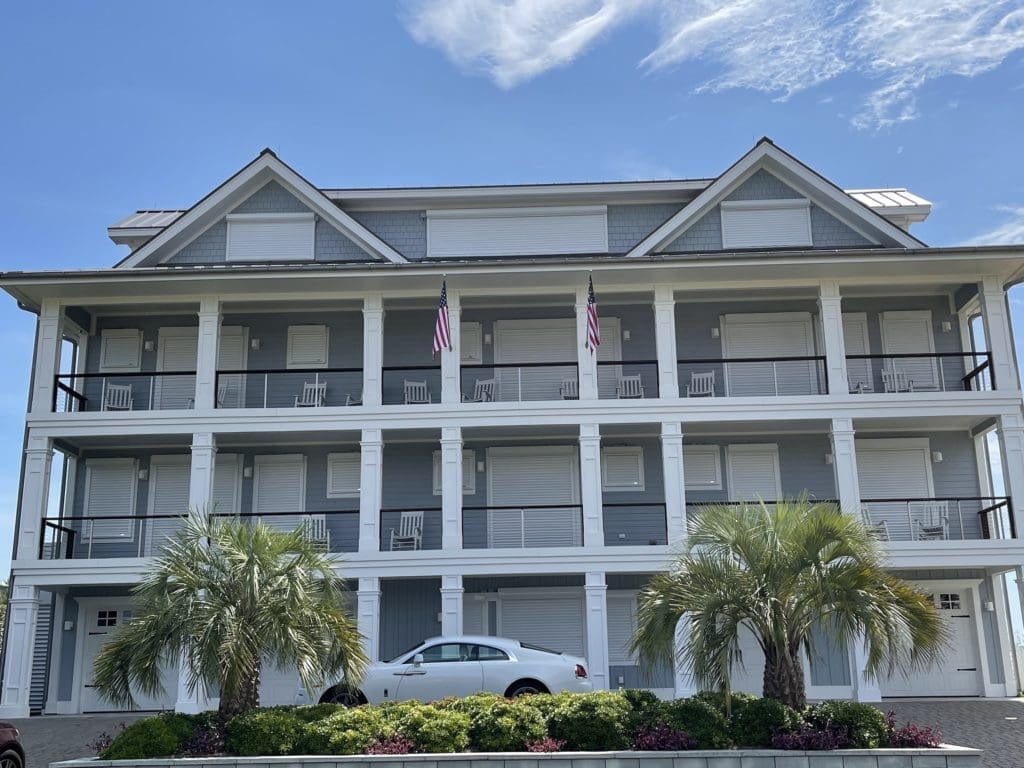 Wilmington coastal luxury home with hurricane shutters - american hurricane shutters Wilmington luxury coastal home with hurricane shutters and sports car.