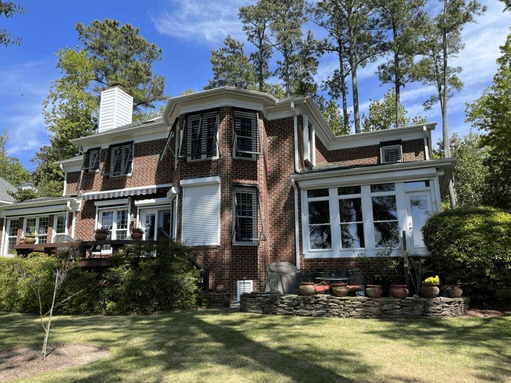Wilmington historic red brick home with sunroom, hurricane shutters.