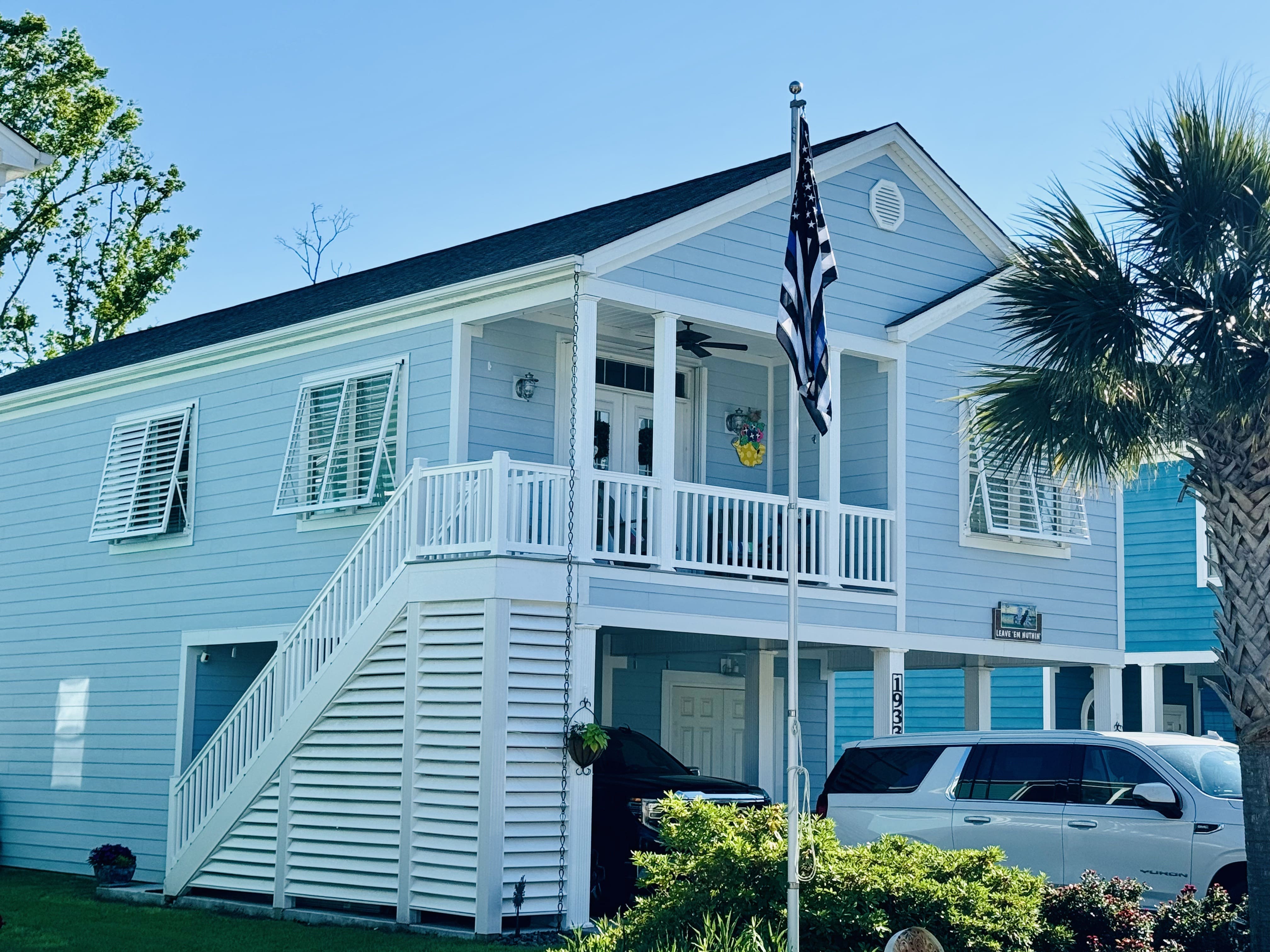 Image of a beachfront house in Emerald Isle, NC with roll-down storm shutters deployed.